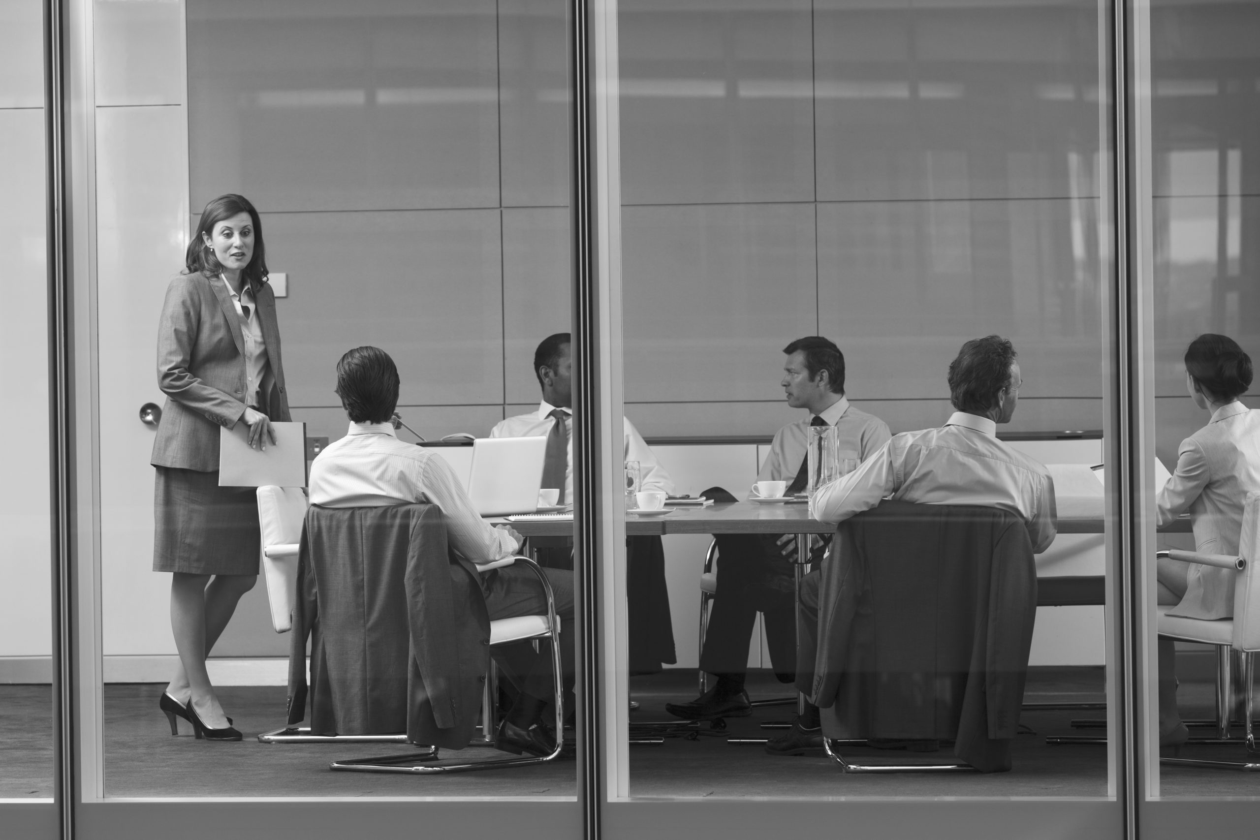 Corporate businesswoman leading conference room meeting